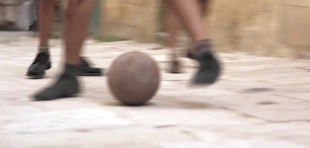 Video Reference: shoe, leg, foot, outdoor shoe, floor, ball, sports equipment, knee, flooring, human leg, Person