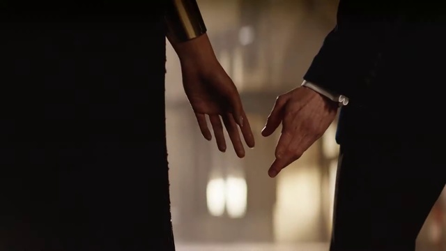 Video Reference: Hand, Finger, Gesture, Fashion, Photography, Holding hands, Still life photography, Wrist, Dress, Fashion accessory, Person, Indoor, Clothing, Cutting, Cake, Man, Knife, Preparing, Cut, Standing, Holding, Woman, Shirt, Dark, Black, Table, Underwear, Kitchen, Wearing, Stove, Watch, Nail