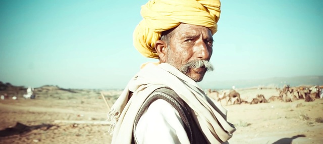 Video Reference: Turban, Dastar, Forehead, Human, Headgear, Landscape, Adaptation, Desert, Moustache, Smile