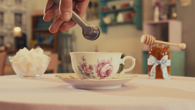 Video Reference: cup, coffee cup, cup, tableware, porcelain, ceramic, table, tea, drinkware, coffee, Person