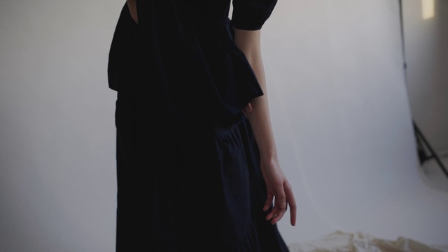 Video Reference: Clothing, Black, Dress, Shoulder, Little black dress, Standing, Waist, Neck, Joint, Sleeve