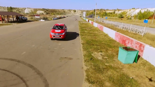 Video Reference: car, road, race track, mode of transport, lane, vehicle, asphalt, race, racing, motor vehicle, Person