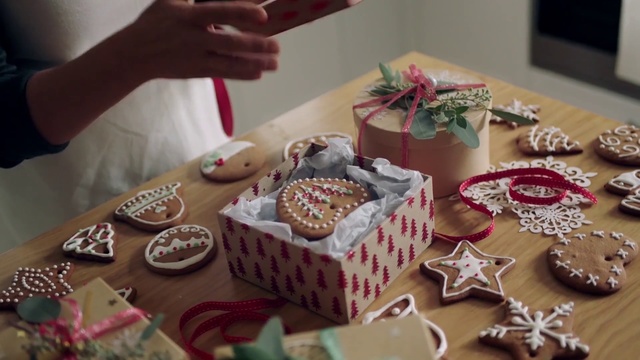 Video Reference: Food, Sugar paste, Sweetness, Dessert, Gingerbread, Icing, Baking, Gingerbread house, Cake decorating, Buttercream, Indoor, Person, Table, Cake, Plate, Holding, Cutting, Chocolate, Sitting, Woman, Kitchen, Little, Eating, Knife, Young, Birthday, Man, Standing, Birthday cake, Baked goods, Snack, Wedding cake, Muffin, Pastry, Candle