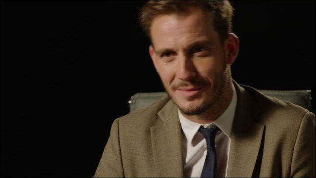 Video Reference: Facial expression, Suit, Forehead, Chin, Cheek, Nose, White-collar worker, Human, Formal wear, Facial hair