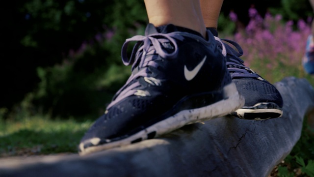 Video Reference: Footwear, Shoe, Black, Purple, Sneakers, Grass, Athletic shoe, Outdoor shoe, Tree, Jeans, Person, Outdoor, Riding, Man, Wearing, Baseball, Standing, Ball, Young, Player, Field, Board, Street, Helmet, Holding, Swinging, Playing, White, Doing, Trick, Game, Bat, Air, Walking shoe, Skateboard, Boot, Sandal, Skate shoe