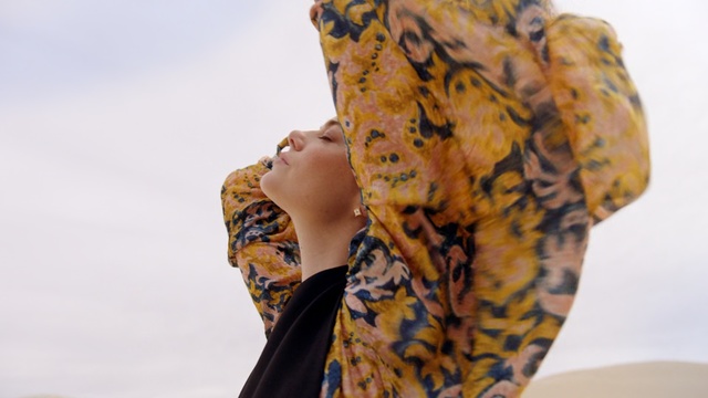 Video Reference: Yellow, Clothing, Scarf, Textile, Fashion accessory, Outerwear, Visual arts, Wrap, Silk, Shawl