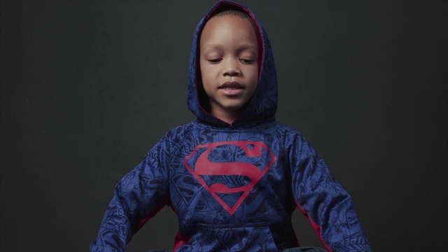 Video Reference: Fictional character, Outerwear, Superhero, Child, Photography, Action figure, Talent show, Black hair, T-shirt