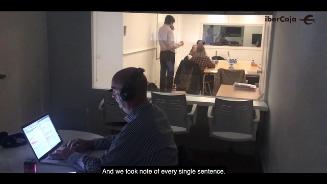 Video Reference: Job, Office, Sitting, Software engineering, Technology, Room, Presentation, Electronic device, Conversation, Multimedia, Man, Indoor, Person, Computer, Front, Laptop, Looking, Table, Desk, Using, Standing, Black, Monitor, Television, Young, Shirt, Living, Woman, People, Text, Clothing, Furniture, Office building