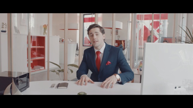 Video Reference: red, suit, gentleman, product, communication, furniture, conversation, screenshot, Person