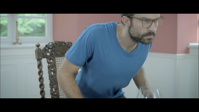 Video Reference: blue, man, shoulder, chin, facial hair, sitting, arm, muscle, human body, neck, Person