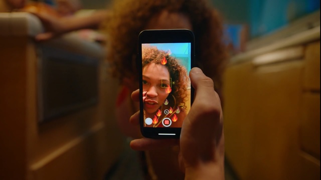 Video Reference: Selfie, Arm, Fun, Technology, Electronic device, Photography, Muscle, Media, Hand, Room, Person, Indoor, Cellphone, Phone, Holding, Man, Front, Camera, Photo, Looking, Screen, Mirror, Young, Using, Orange, Sitting, Monitor, Face, Woman, Standing, Boy, Wearing, Table, Computer, Television, Mobile phone, Screenshot, Human face, Portable communications device, Gadget