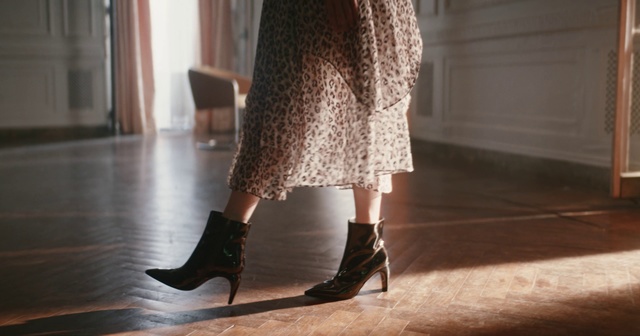 Video Reference: Footwear, Clothing, Leg, Human leg, High heels, Ankle, Brown, Boot, Shoe, Joint, Floor, Indoor, Window, Woman, Table, Girl, Small, Little, Living, Young, Standing, Holding, Riding, Black, Room, Wearing, Red, White, Kitchen, Dress, Sandal, Skirt, Fashion accessory, Fashion, Handbag, Miniskirt, Fashion design, Coat, Fashion model, Day dress, Tights, Street fashion, Waist, One-piece garment, Trousers, Stocking, Knee-high boot, Cocktail dress, Court shoe, Knee, Sock, Casual dress, Person