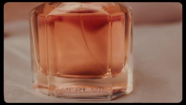 Video Reference: Glass bottle, Peach, Perfume, Caramel color, Fluid, Drink, Liquid, Glass, Drinkware, Bottle