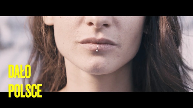 Video Reference: Face, Hair, Lip, Skin, Chin, Cheek, Nose, Eyebrow, Jaw, Beauty, Person, Looking, Woman, Man, Wearing, Young, Holding, Black, Close, Standing, White, Shirt, Red, Room, Hat, Eyes, Human face, Portrait, Text, Lipstick, Eyelash, Forehead