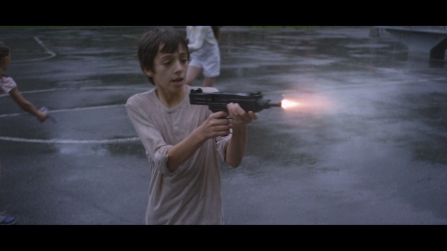 Video Reference: Gun, Firearm, Gunshot, Movie, Assault rifle, Airsoft gun, Sport venue, Rifle, Laser guns, Photography, Person, Weapon, Thing, Holding, Young, Street, Man, Girl, Standing, Little, Woman, Walking, Boy, Playing, Night, Riding, Umbrella, Rain, White, Phone, Ball, Baseball, Room, Camera, Shotgun, Handgun