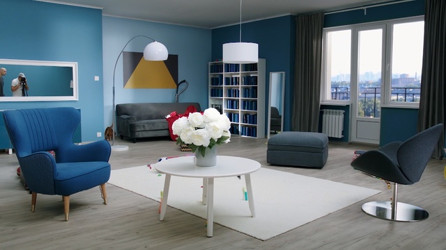 Video Reference: room, living room, interior design, table, furniture, suite, window, home, chair, floor, Person