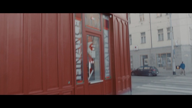 Video Reference: red, wall, urban area, mode of transport, snapshot, architecture, shipping container, home, line, sky, Person