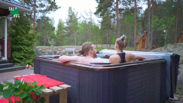 Video Reference: Jacuzzi, Leisure, Vacation, Bathtub, Outdoor, Table, Sitting, Picnic, Woman, Wooden, Man, Bench, Front, Red, Young, Standing, Park, Holding, Garden, People, Tree, Person, Clothing, Water