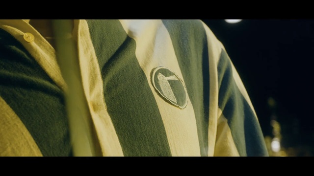 Video Reference: Clothing, Green, Yellow, Jacket, Outerwear, Fashion, Sleeve, Jersey, Font, T-shirt
