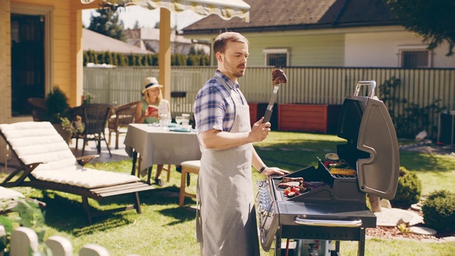 Video Reference: Outdoor grill, Barbecue, Table, Backyard, Barbecue grill, Furniture, Yard, Cuisine, Recreation, Cooking