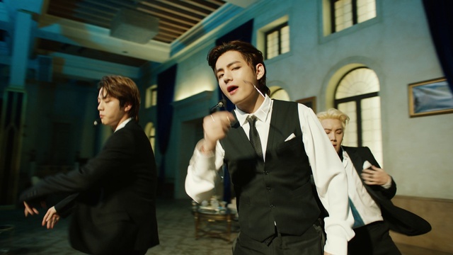 Video Reference: Window, Coat, Flash photography, Gesture, Dress shirt, Formal wear, Blazer, Fashion design, White-collar worker, Suit