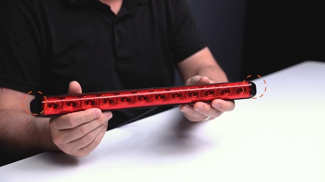 Video Reference: Musical instrument, Traditional japanese musical instruments, String instrument accessory, Folk instrument, Pipe, Indian musical instruments, Flute, Dizi, Plucked string instruments, Person, Holding, Indoor, Man, Hand, Red, Black, Remote, Front, Looking, Video, Sitting, Using, Boy, Young, Playing, Screen, Shirt, White, Wearing, Table, Control, Wii, Standing, Game, Room, Music