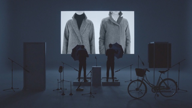 Video Reference: standing, design, clothes hanger, furniture, lamp, table, fashion design, gentleman, Person