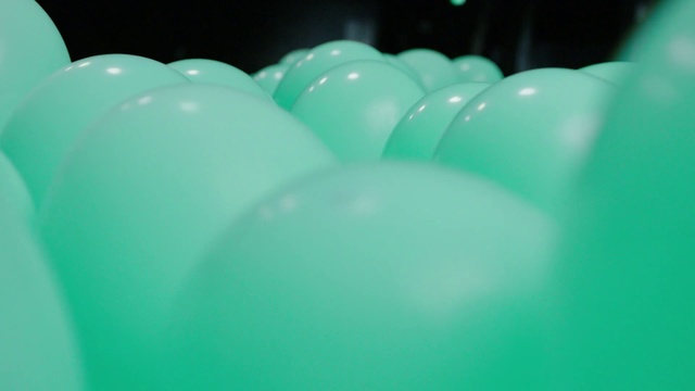 Video Reference: Green, Blue, Turquoise, Balloon, Aqua, Teal, Party supply, Material property, Ball, Cup, Indoor, Sport, Sitting, Table, Bowl, Filled, Food, Glass, Close, White, Pink, Plate, Holding, Sink, Soup, Pool ball