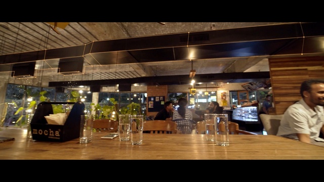 Video Reference: Restaurant, Building, Night, Sky, Bar, Table, Glass, Café, Drink, Music venue, Person