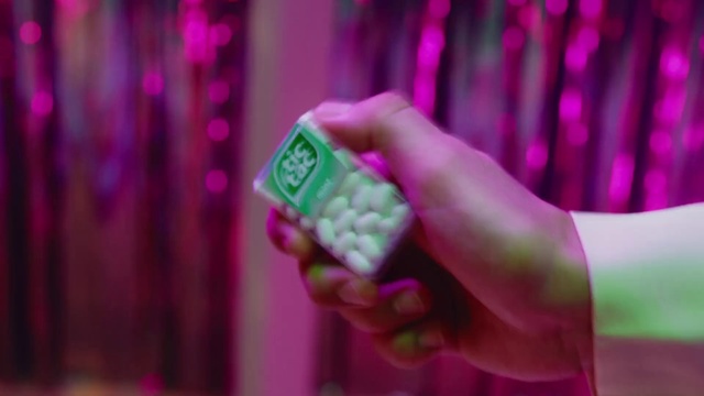Video Reference: Pink, Magenta, Purple, Violet, Finger, Hand, Nail, Petal, Person, Indoor, Holding, Food, Table, Small, Phone, Front, Sitting, Remote, Using, Wearing, Little, Colorful, Young, Shirt, Control, Green, Red, Standing, Man, White, Room, Curtain