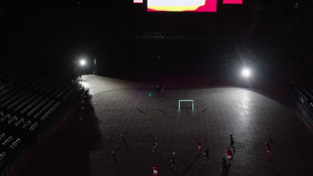 Video Reference: Light, Sky, Stage, Night, Performance, Sport venue, Arena, Outdoor, Street, Dark, Red, Monitor, Sitting, Traffic, Sign, City, Large, Standing, Table, People, White, Water, Station, Man, Parked, Text, Concert