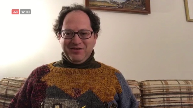 Video Reference: glasses, vision care, outerwear, eyewear, facial hair, smile, knitting, product, Person