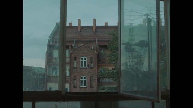 Video Reference: Green, Architecture, Window, Snapshot, Glass, House, Urban area, Facade, Tree, Building, Person, View, Sitting, Front, Large, Table, Water, Sign, Wooden, Room, Brick, Standing, White, Stop, Street, Red, Door, Tall, Clock, Sky