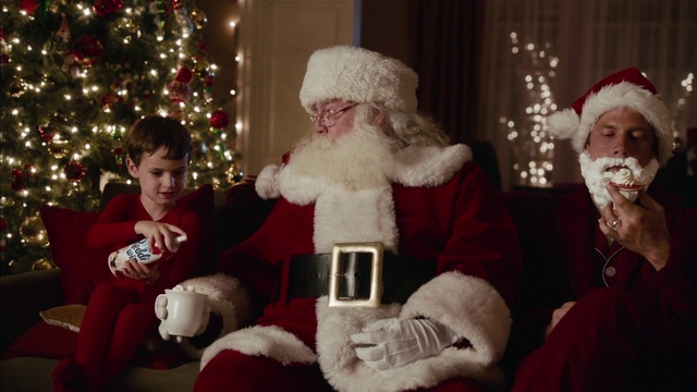Video Reference: Santa claus, Christmas, Christmas eve, Holiday, Fictional character, Lap, Christmas ornament, Christmas tree, Christmas lights, Event, Person