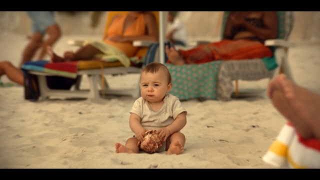 Video Reference: Child, Adaptation, Human, Sitting, Smile, Sand, Fun, Toddler, Vacation, Play, Person