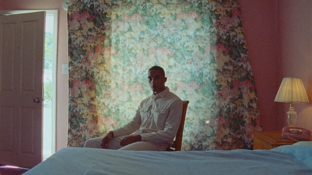 Video Reference: Room, Bed, Furniture, Wall, Wallpaper, Textile, Sitting, Bedroom, Bed sheet, Plaster