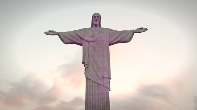 Video Reference: Religious item, Landmark, Statue, Purple, Sky, Pink, Standing, Monument, Cross, Wonders of the world