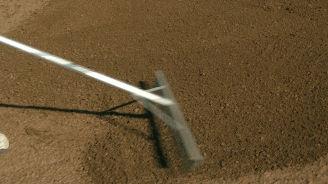 Video Reference: Soil, Line, Floor, Sand, Flooring, Outdoor, Baseball, Player, Man, Ball, Field, Bat, Game, Plate, Empty, White, Standing, Red, Swinging, Batter, Playing, Dirt, Pitch, Air, Ground