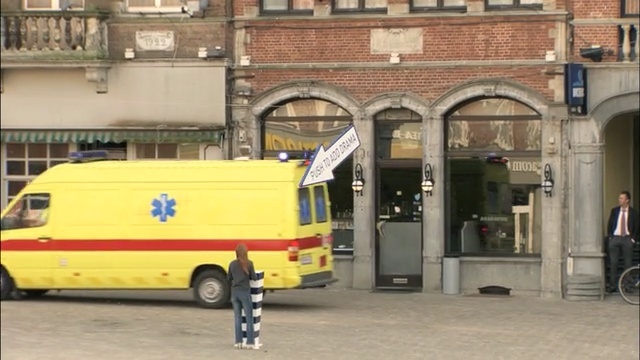 Video Reference: motor vehicle, vehicle, transport, mode of transport, car, metropolitan area, emergency vehicle, street, commercial vehicle, facade, Person