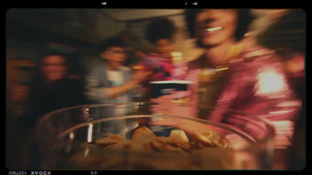 Video Reference: Snapshot, Fun, Font, Photography, Cuisine, Indoor, Food, Monitor, Table, Sitting, Oven, Plate, Television, Kitchen, Man, Blurry, Woman, Counter, Cooking, Silver, Restaurant, Screen, Large, Cooked, Pan, Microwave, White, Holding, Pizza, Stove, Red, People, Standing, Bus, Display, Fast food, Person, Human face, Text, Dish
