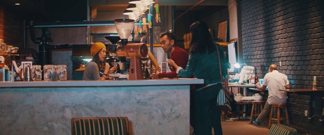 Video Reference: Street food, Person, Building, Man, Table, Woman, Sitting, People, Young, Standing, Doing, Room, Food, Bench, Walking, Computer, Group, Kitchen, Restaurant, Riding, Counter, Luggage, Street, Board, City, Clothing, Human face, Bottle