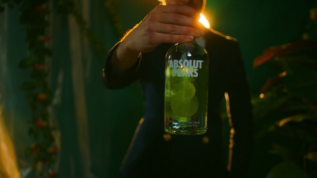 Video Reference: Green, Light, Alcohol, Glass bottle, Drink, Liqueur, Hand, Bottle, Distilled beverage, Night