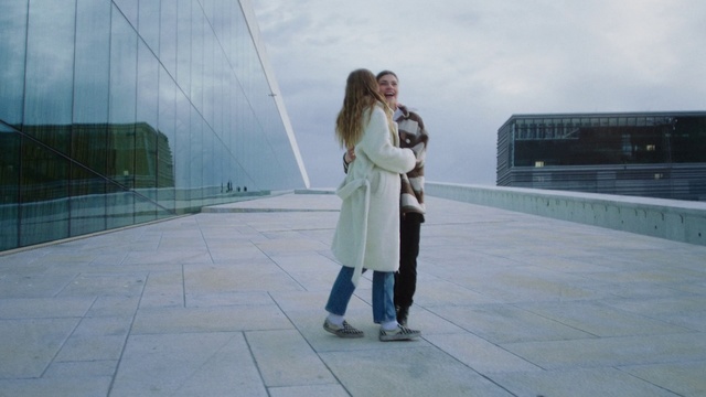 Video Reference: Photograph, Snapshot, Standing, Trench coat, Photography, Footwear, Coat, Outerwear, Street fashion, Uniform