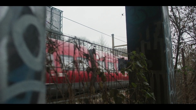Video Reference: mode of transport, residential area, urban area, structure, fence, sky, tree, building, wire fencing, area