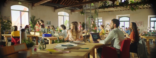 Video Reference: Event, Room, Learning, Workshop, Table, Art, Building, Education, Interior design, Restaurant, Person, Indoor, Laptop, Computer, Sitting, Woman, Man, People, Front, Desk, Looking, Office, Using, Young, Group, Food, Talking, Standing, Holding, Phone, Playing, Clothing, Furniture, Working, Classroom, Dining table