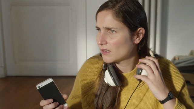 Video Reference: hairstyle, electronic device, audio equipment, audio, long hair, girl, ear, brown hair, Person