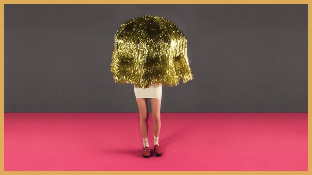 Video Reference: Clothing, Fashion, Dress, Yellow, Pink, Flooring, Shoulder, Red carpet, Fashion model, Footwear, Woman, Shirt, Text, Skirt, Fashion design, High heels