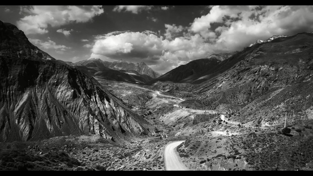 Video Reference: Mountainous landforms, Mountain, Highland, Nature, Sky, Black-and-white, Mountain range, Cloud, Monochrome photography, Valley, Person