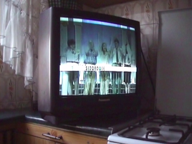 Video Reference: Screen, Television set, Property, Television, Display device, Media, Room, Technology, Electronic device, Multimedia