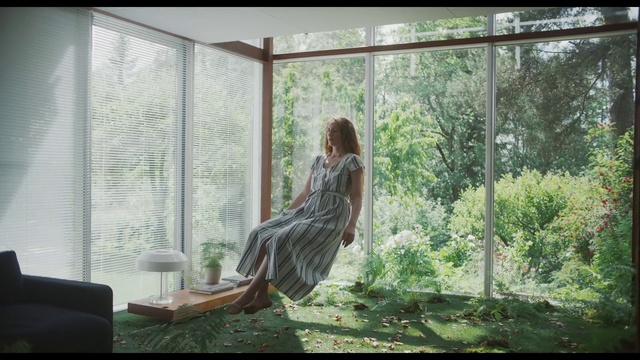 Video Reference: Nature, Tree, Sunlight, Adaptation, Window, Sitting, Organism, Interior design, Plant, Room, Indoor, Building, Looking, Table, Living, Front, Open, Large, Standing, Glass, Sun, Water, White, Bed, Girl, Fashion, Clothing, Person, Woman, Furniture, Dress